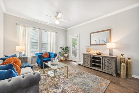 a living room with furniture and a ceiling fan